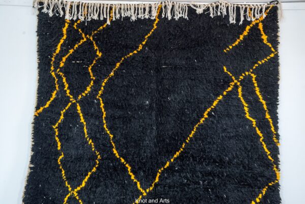 black moroccan rug decorated with modern golden lines for living room