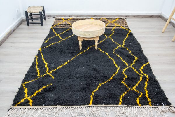 black moroccan rug decorated with modern golden lines for living room