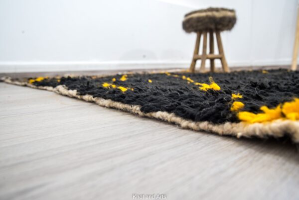 black moroccan rug decorated with modern golden lines for living room