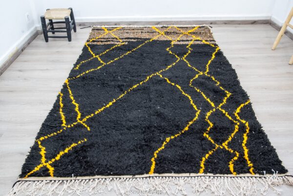 black moroccan rug decorated with modern golden lines for living room