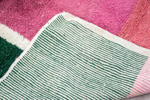 Colorful Moroccan rug with a beautiful abstract pink, green white pattern for a modern living room