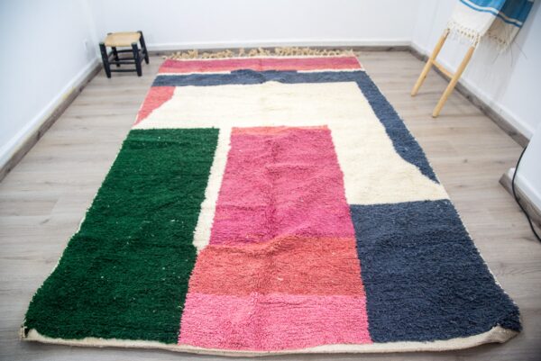 Colorful Moroccan rug with a beautiful abstract pink, green white pattern for a modern living room