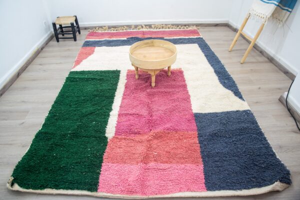 Colorful Moroccan rug with a beautiful abstract pink, green white pattern for a modern living room