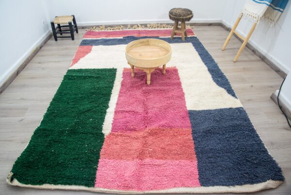 Colorful Moroccan rug with a beautiful abstract pink, green white pattern for a modern living room