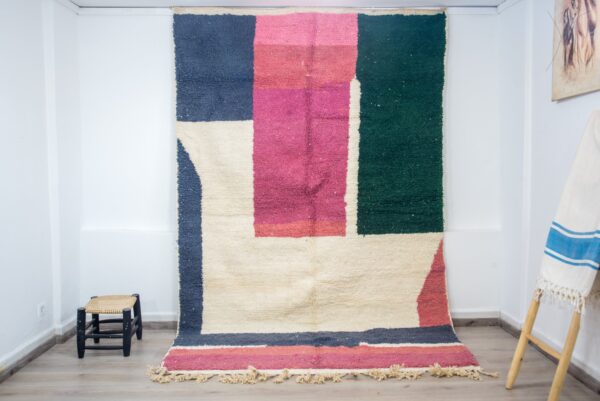 Colorful Moroccan rug with a beautiful abstract pink, green white pattern for a modern living room