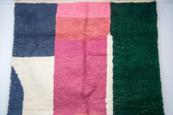 Colorful Moroccan rug with a beautiful abstract pink, green white pattern for a modern living room