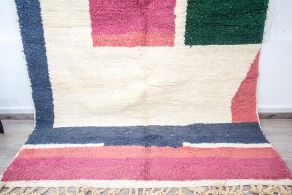 Colorful Moroccan rug with a beautiful abstract pink, green white pattern for a modern living room